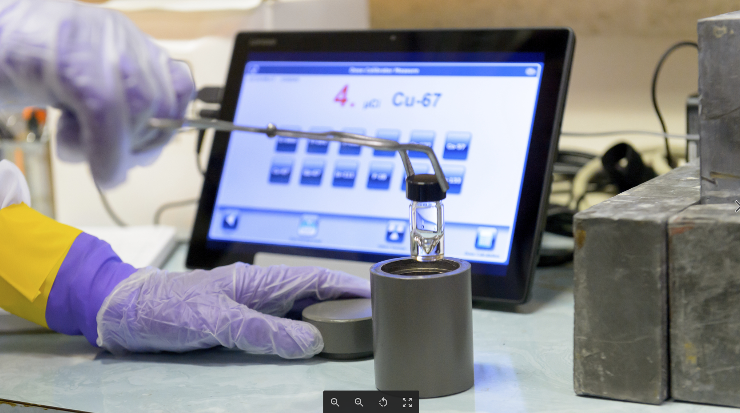 Argonne scientist placing a vial of Cu-67 into a lead pig prior to shipping