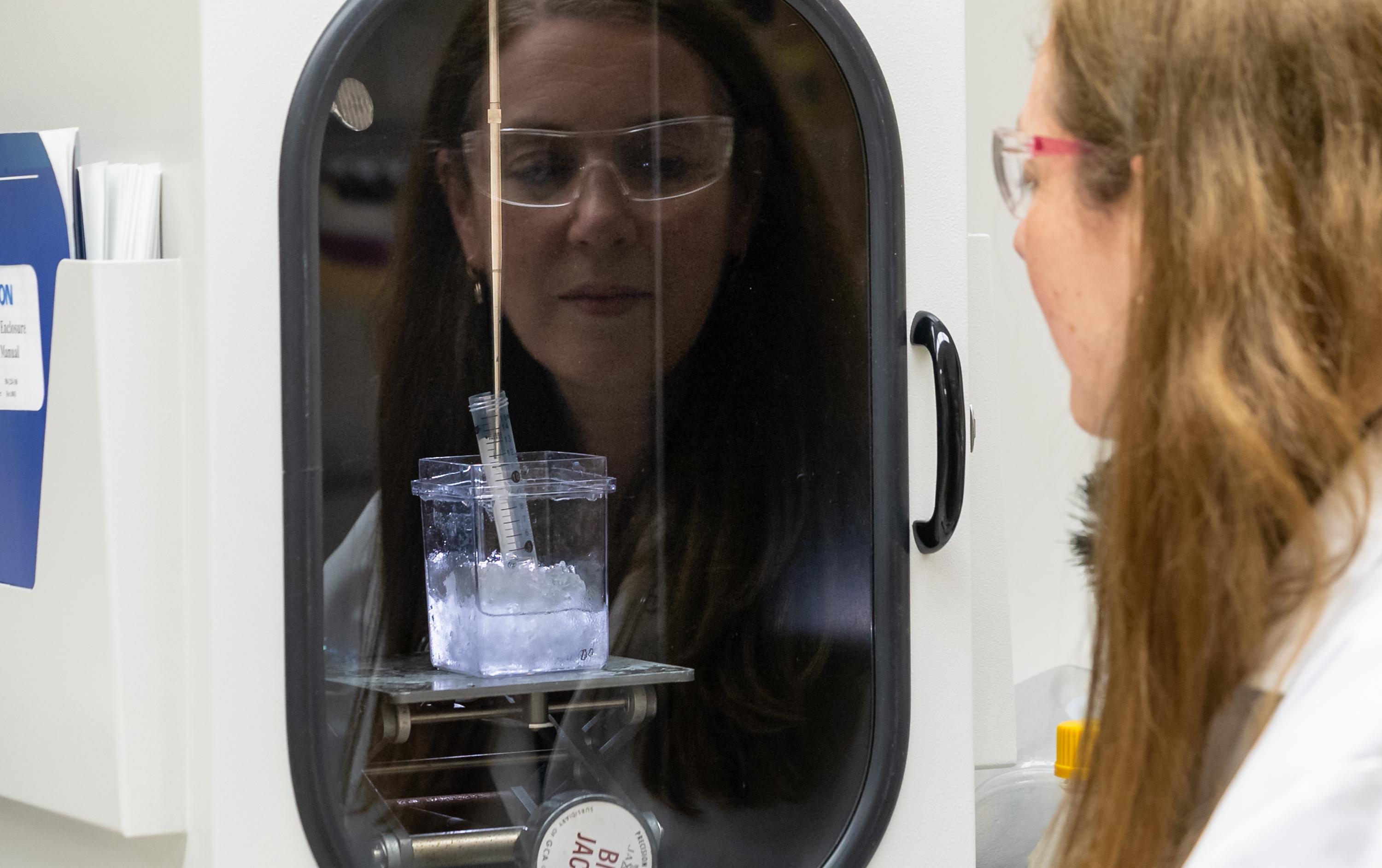 Image courtesy of Carlos Jones, Oak Ridge National Laboratory Researcher Sandra Davern looks at non-radioactive metal ions enclosed in biodegradable polymers in her lab at Oak Ridge National Laboratory. Her work is paving the way for enclosing isotopes in the same polymers for targeted treatment of cancer cells.