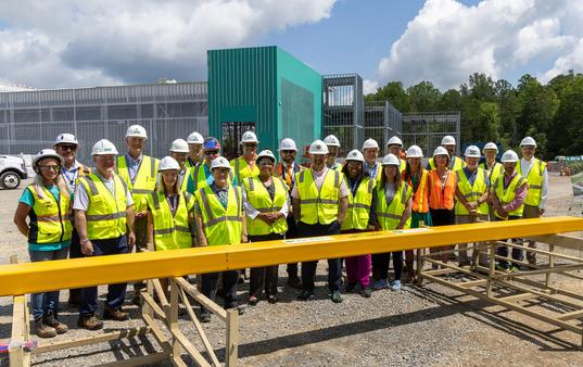 DOE Office of Isotope R&D and Production and ORNL staff gather for a group photo at the Stable Isotope Production and Research Center (SIPRC) construction site during a tour.