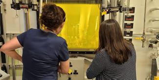 ORNL technicians Summer Widner, left, and Stephanie Timbs process thorium-228 in a hot cell.